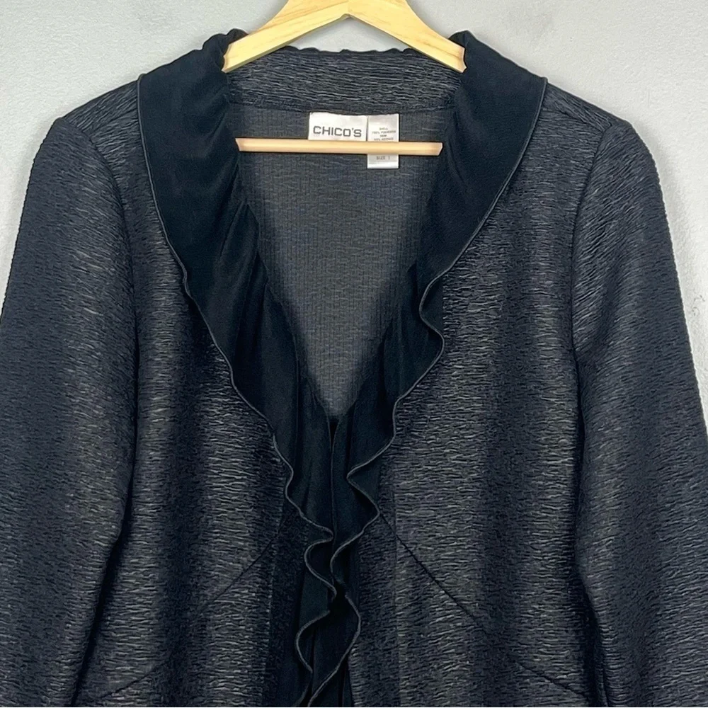 Chico’s black textured ruffled shawl collar single hook closure jacket, medium.